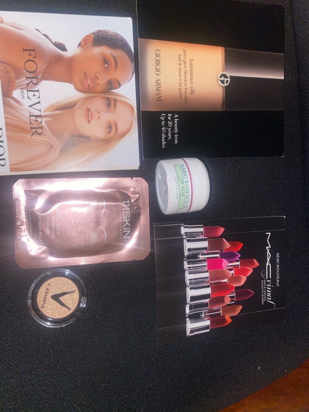 Assortment of cosmetics (MAC Cosmetics Lipstick Sample Card etc.)